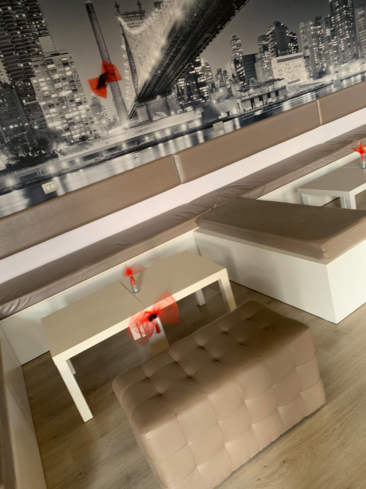 Aspesi Cafe interior with seating and wall art